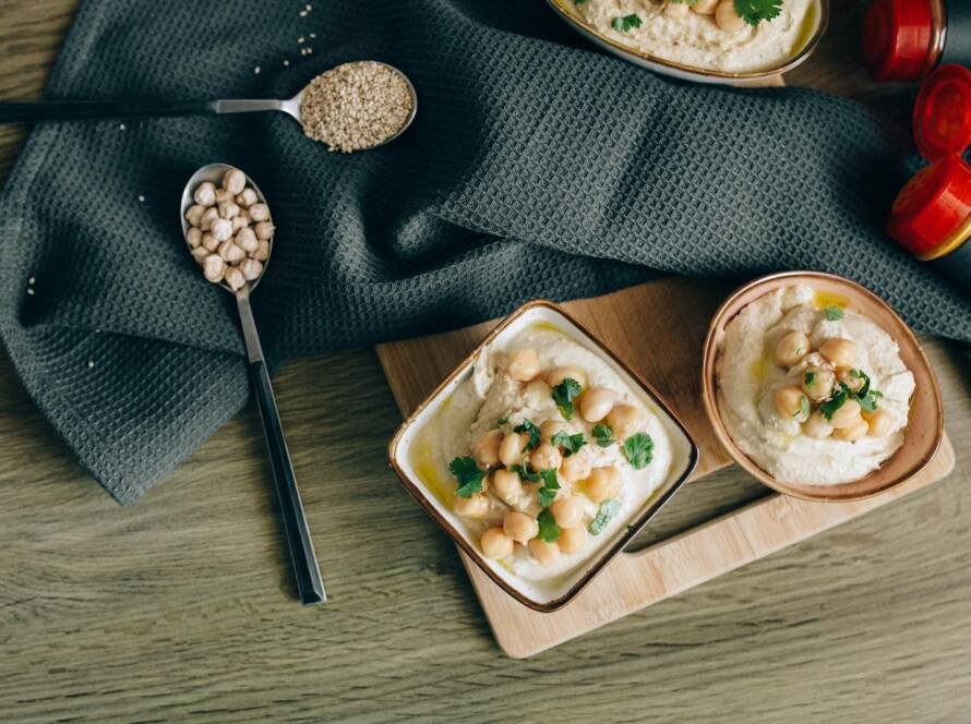 Overhead Shot of Hummus Near Spoons